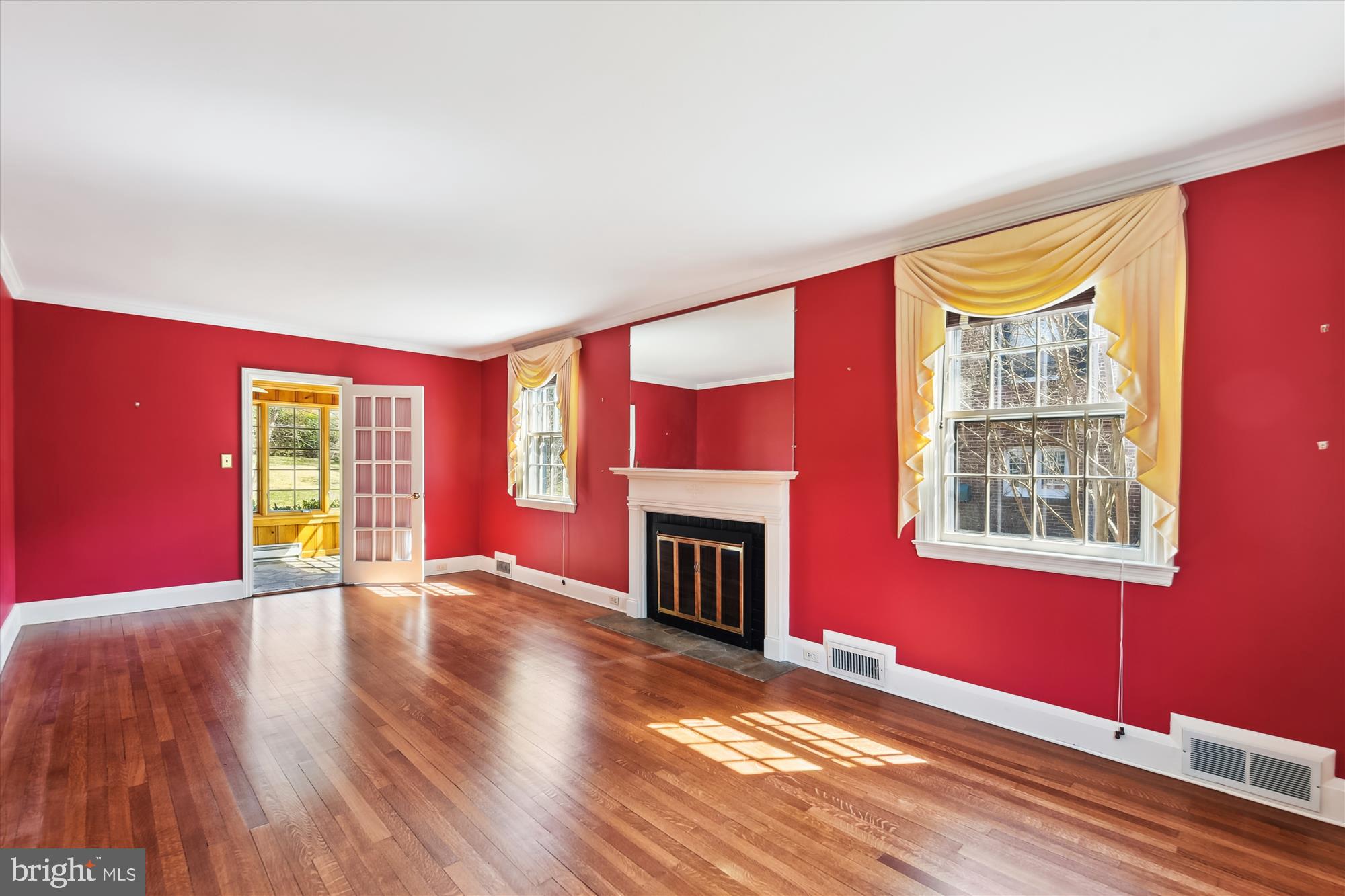 5433 Springlake Way Baltimore, MD 21212 - Photo 5 of 58 a view of an empty room with wooden floor and a window