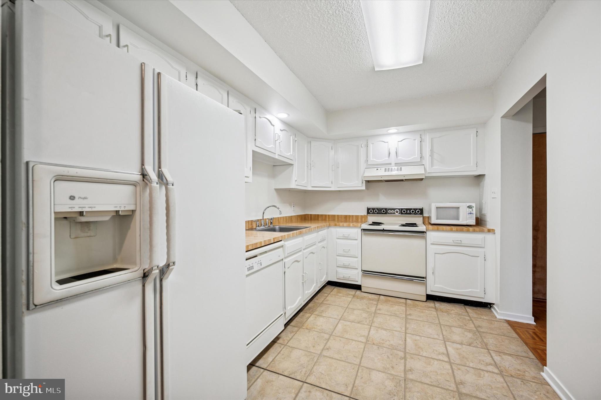 19 Rock Hill Road, Unit 7D Bala Cynwyd, PA 19004 - Photo 20 of 37 a kitchen with a refrigerator sink and cabinets