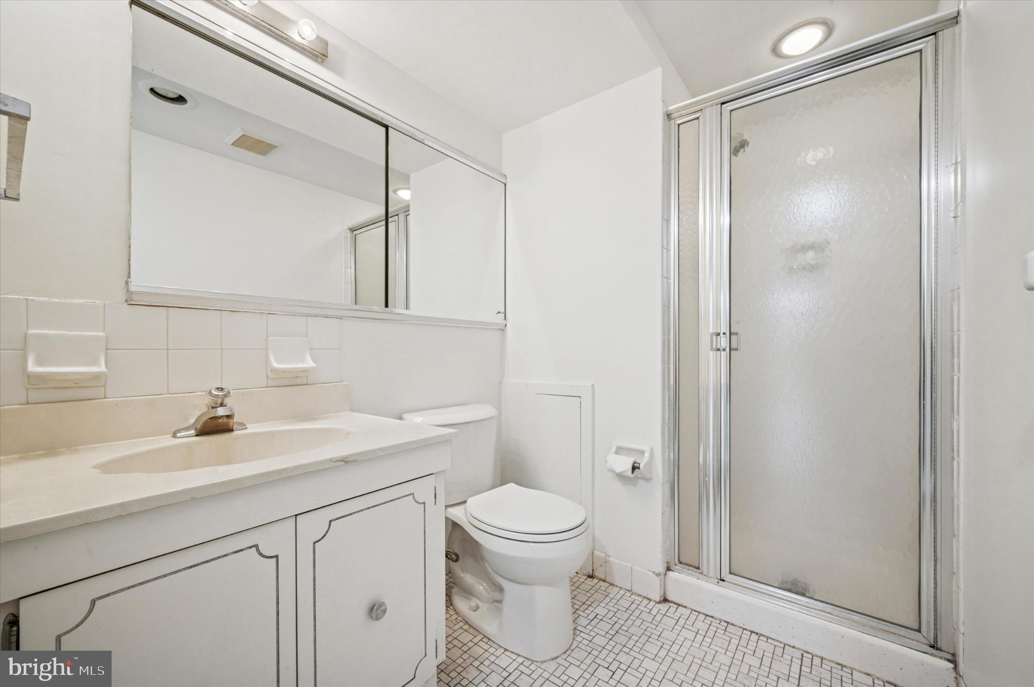 19 Rock Hill Road, Unit 7D Bala Cynwyd, PA 19004 - Photo 26 of 37 a bathroom with a sink a toilet and a mirror