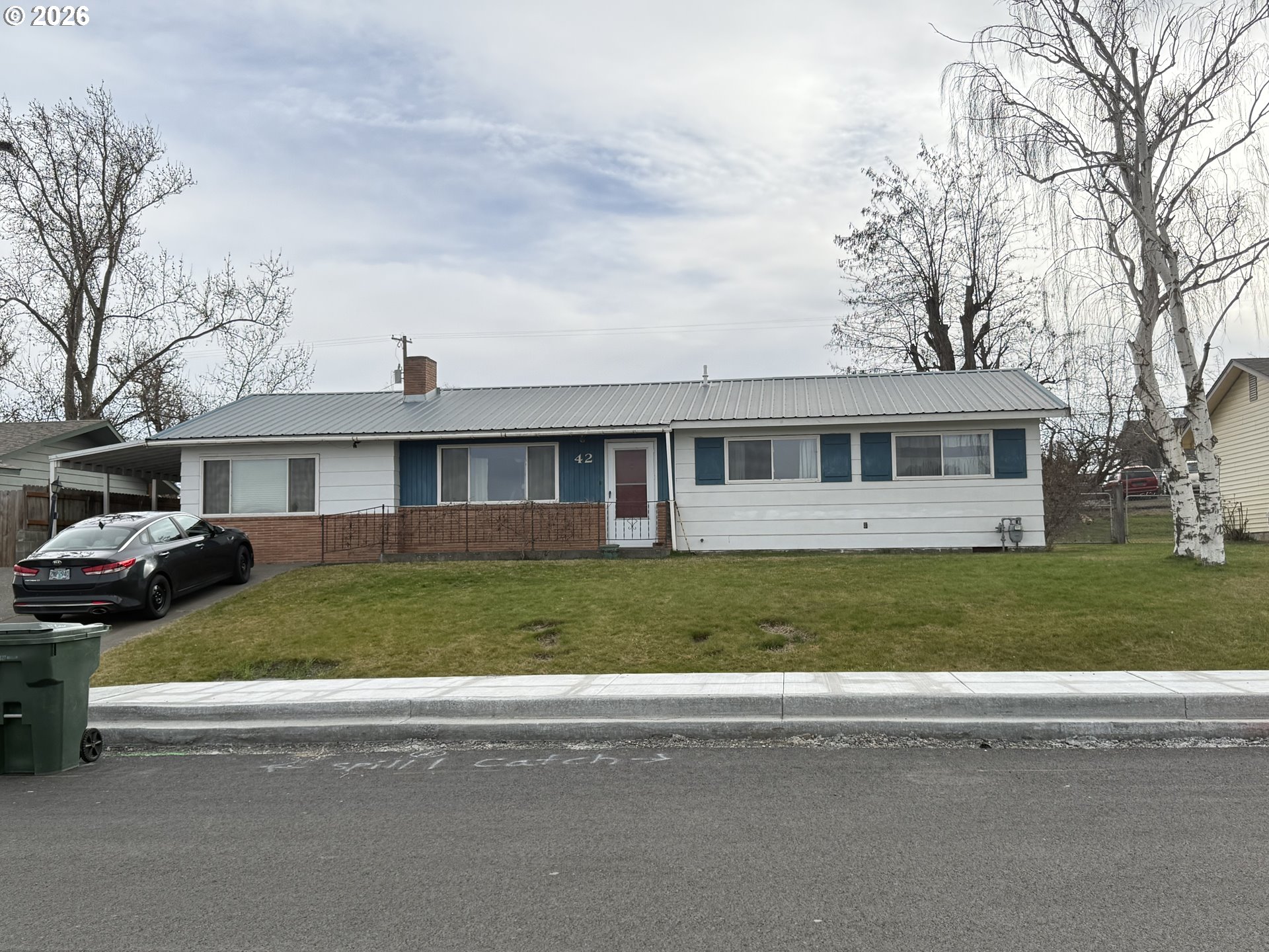 a front view of a house with a garden
