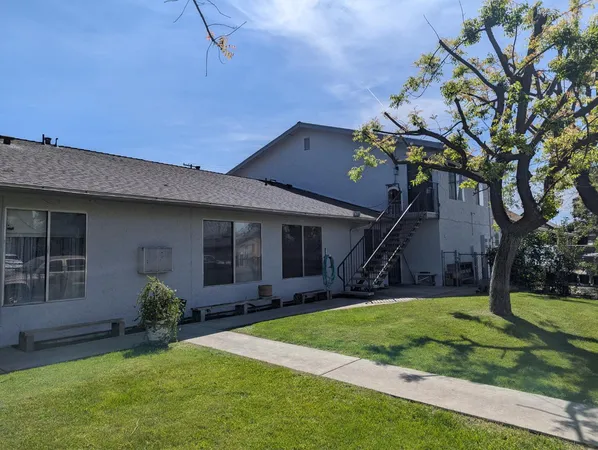 a house that has a tree in front of the house
