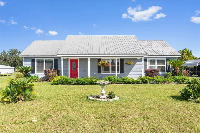a front view of a house with garden and porch