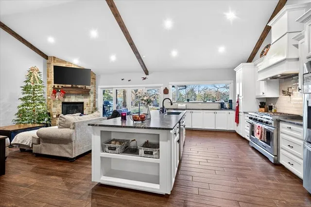 a living room with furniture fireplace and flat screen tv