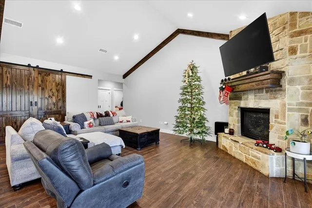 a living room with furniture fireplace and flat screen tv