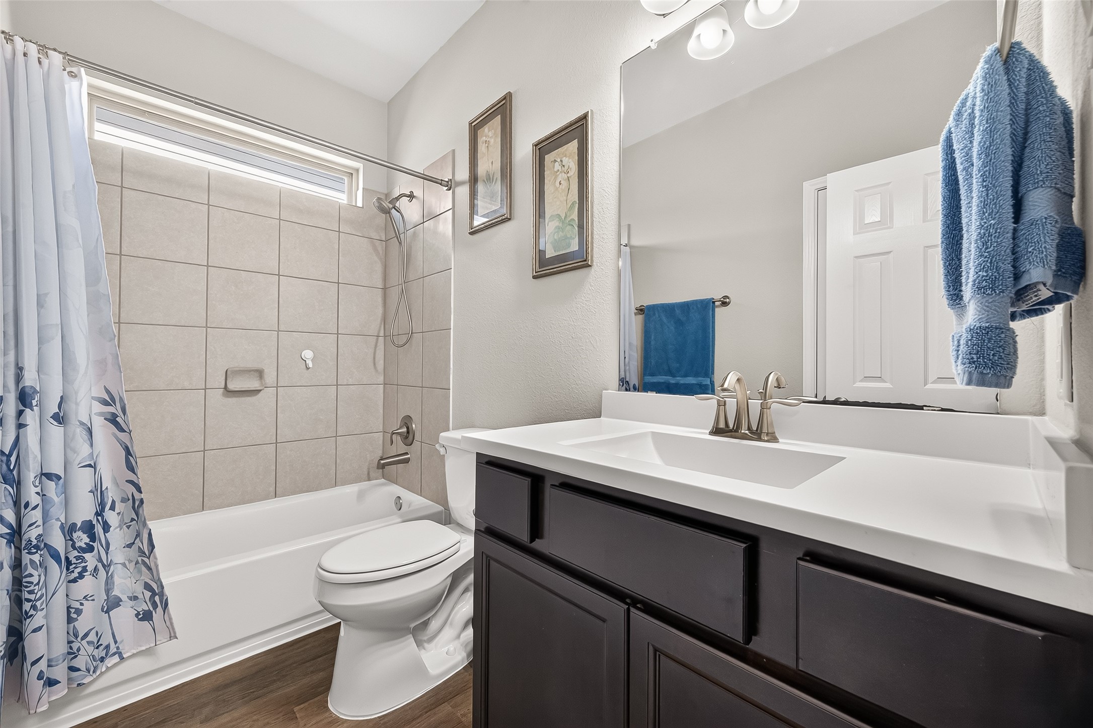 1329 Red Hills Drive Rosharon, TX 77583 - Photo 19 of 27 Secondary bathroom features a clean, modern design with a tiled shower-tub combo, a sleek vanity with faucets. A large mirror and tasteful decor provide a welcoming touch.