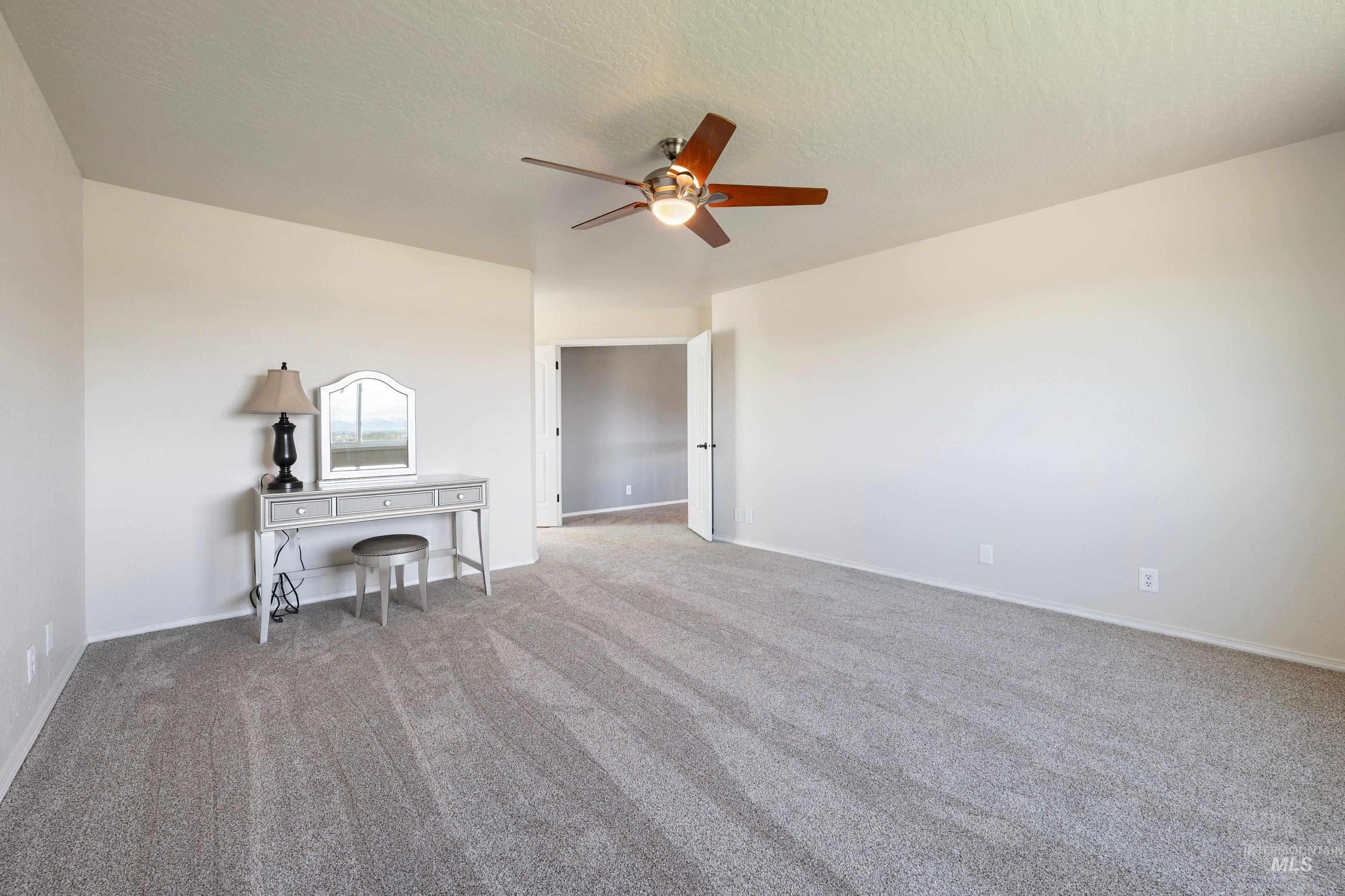 7657 Track Road Nampa, ID 83686 - Photo 21 of 49 Spacious interior room featuring light-colored walls and grey patterned carpet