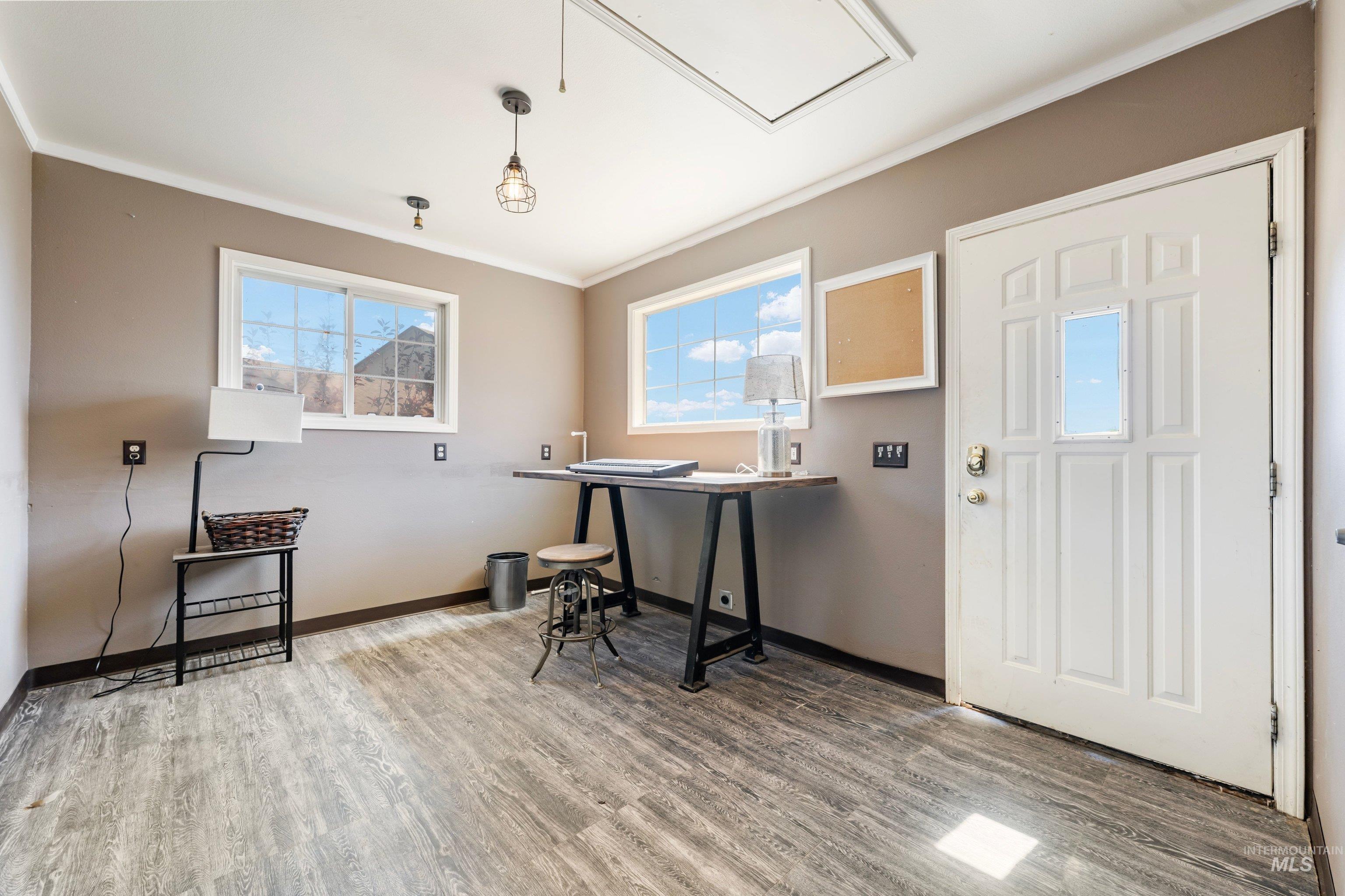7657 Track Road Nampa, ID 83686 - Photo 34 of 49 Interior space featuring wood-finish flooring, two window units, and a white paneled door