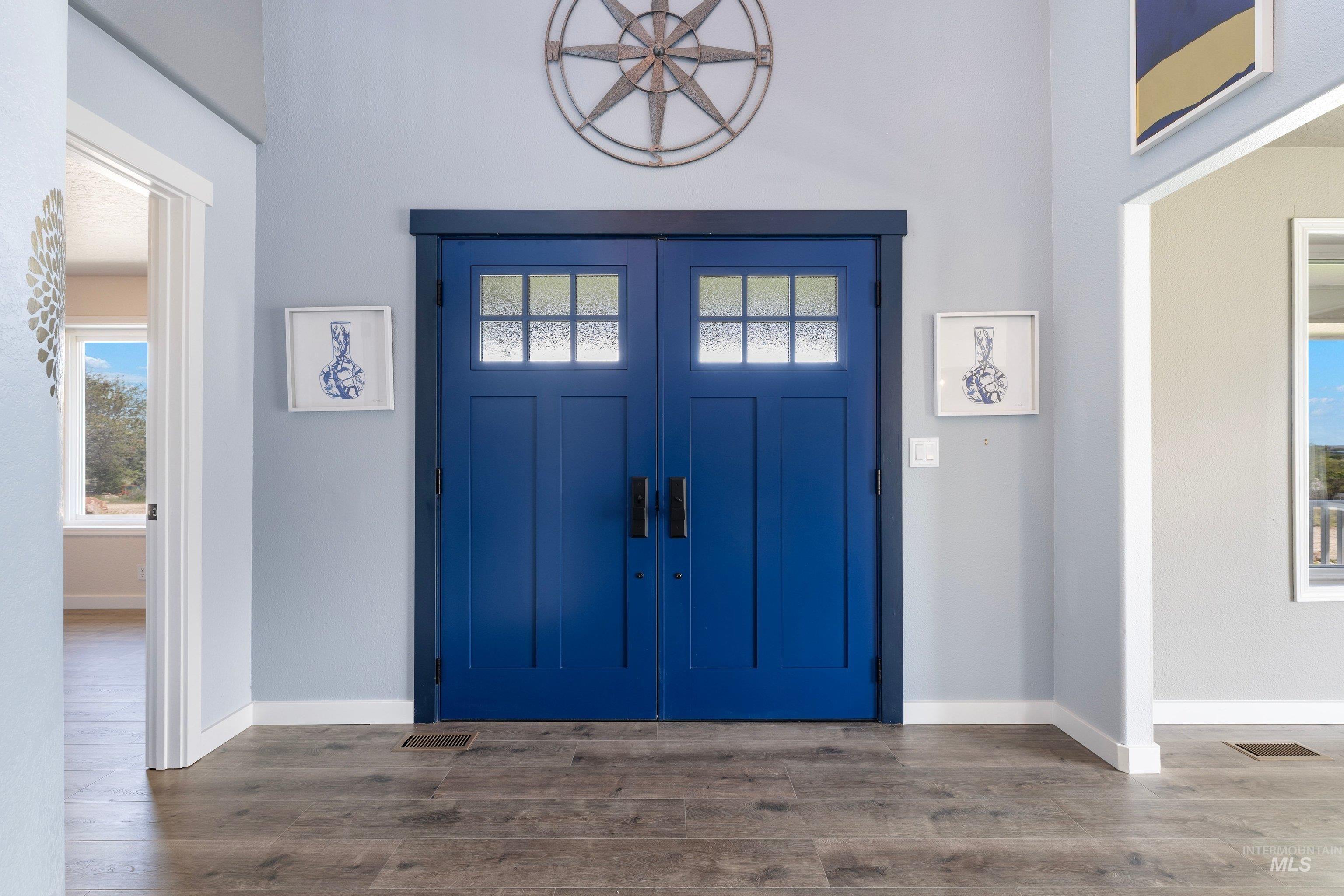 7657 Track Road Nampa, ID 83686 - Photo 4 of 49 Double entry doors in a vibrant blue finish with frosted glass panels