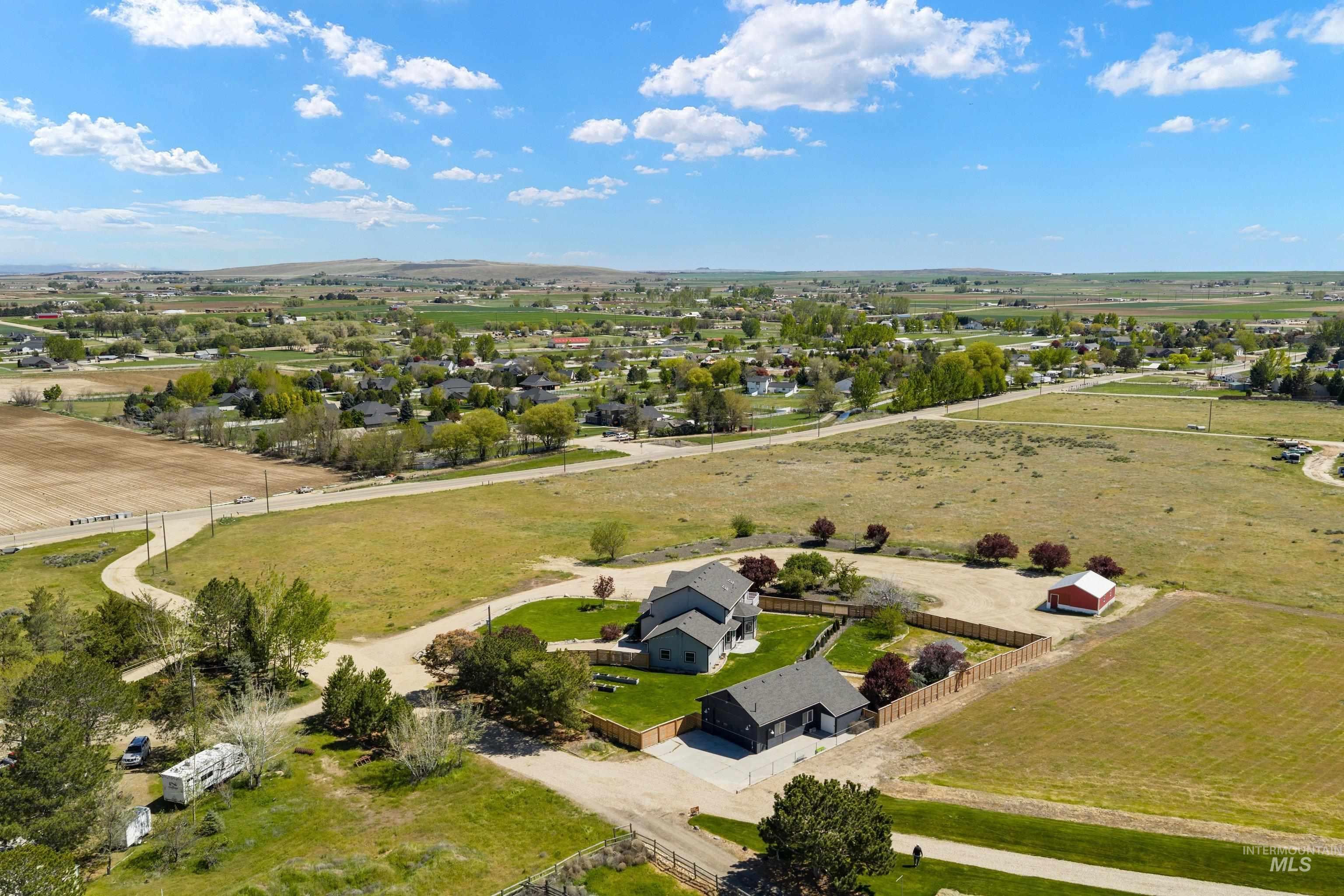 7657 Track Road Nampa, ID 83686 - Photo 42 of 49 Expansive property featuring two residential structures, a detached red barn, and a large fenced yard