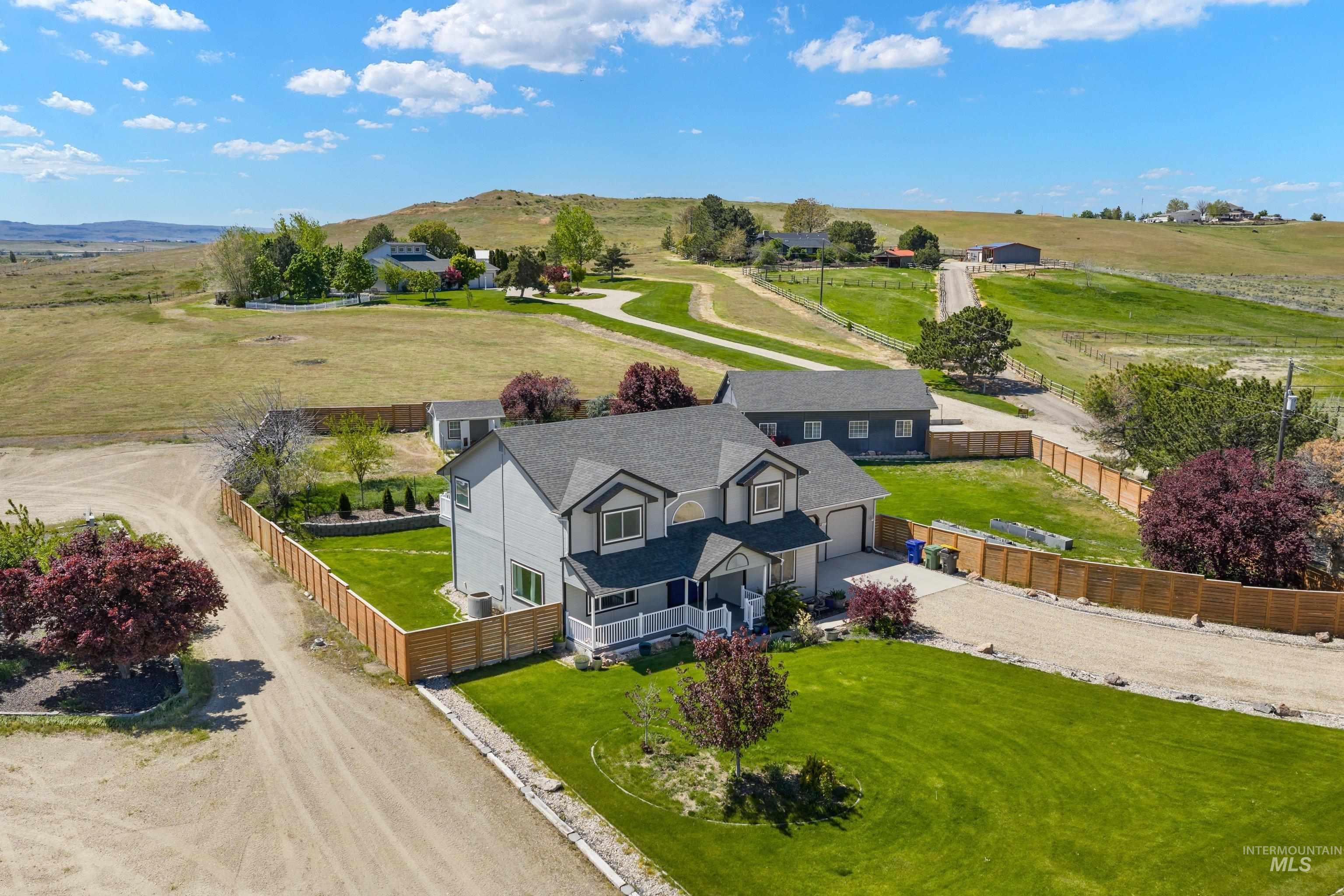 7657 Track Road Nampa, ID 83686 - Photo 44 of 49 Expansive property featuring a two-story home with a light gray exterior and dark gray roof