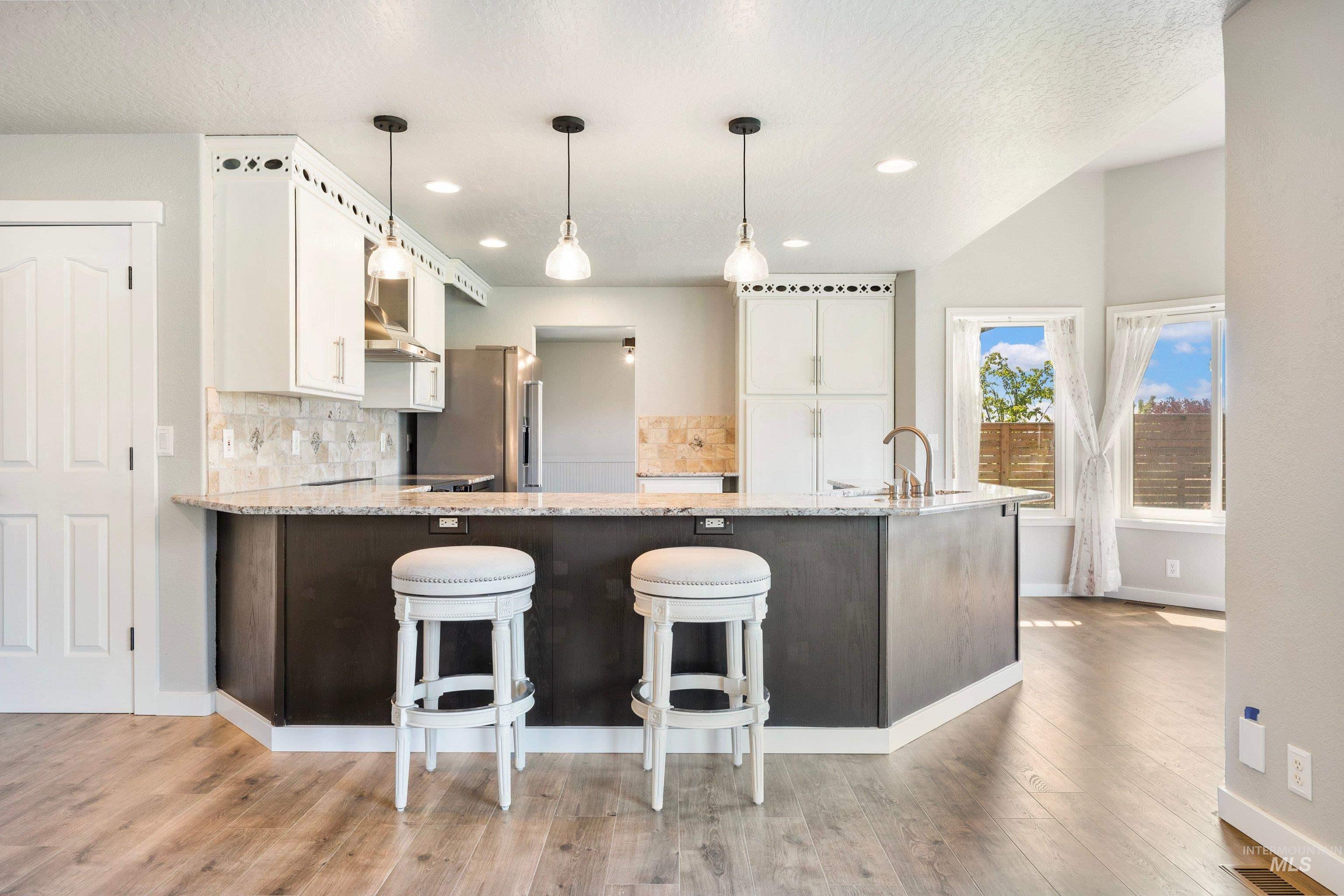 7657 Track Road Nampa, ID 83686 - Photo 9 of 49 Kitchen island with a granite-style countertop and dark wood-finish cabinetry