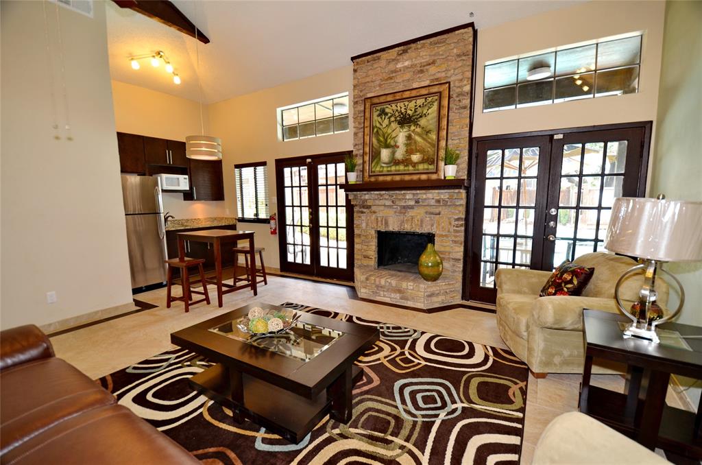 5630 Spring Valley Road, Unit 19B Dallas, TX 75254 - Photo 19 of 25 a living room with furniture and a fireplace