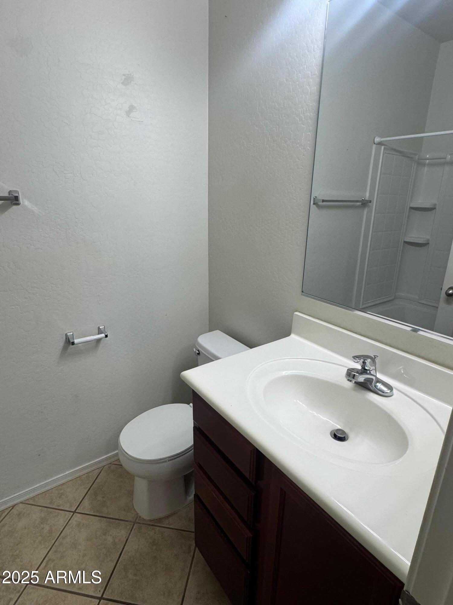 8105 West Groom Creek Road Phoenix, AZ 85043 - Photo 10 of 13 a bathroom with a sink toilet and mirror