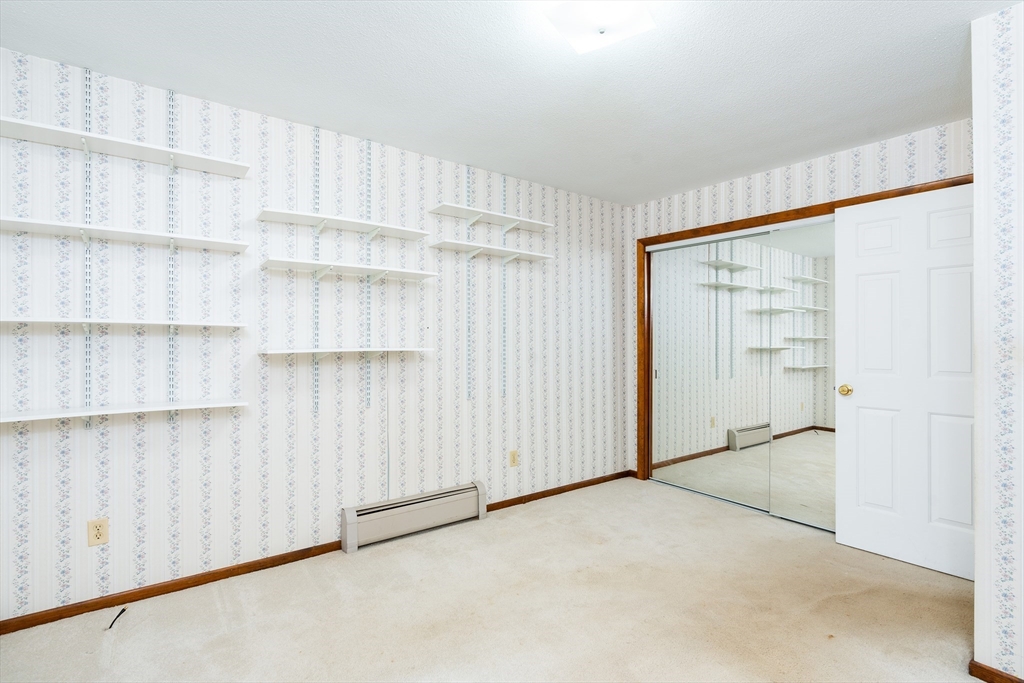135 Blake Corner Road Phillipston, MA 01331 - Photo 24 of 42 a view of an empty room with cabinet and stairs