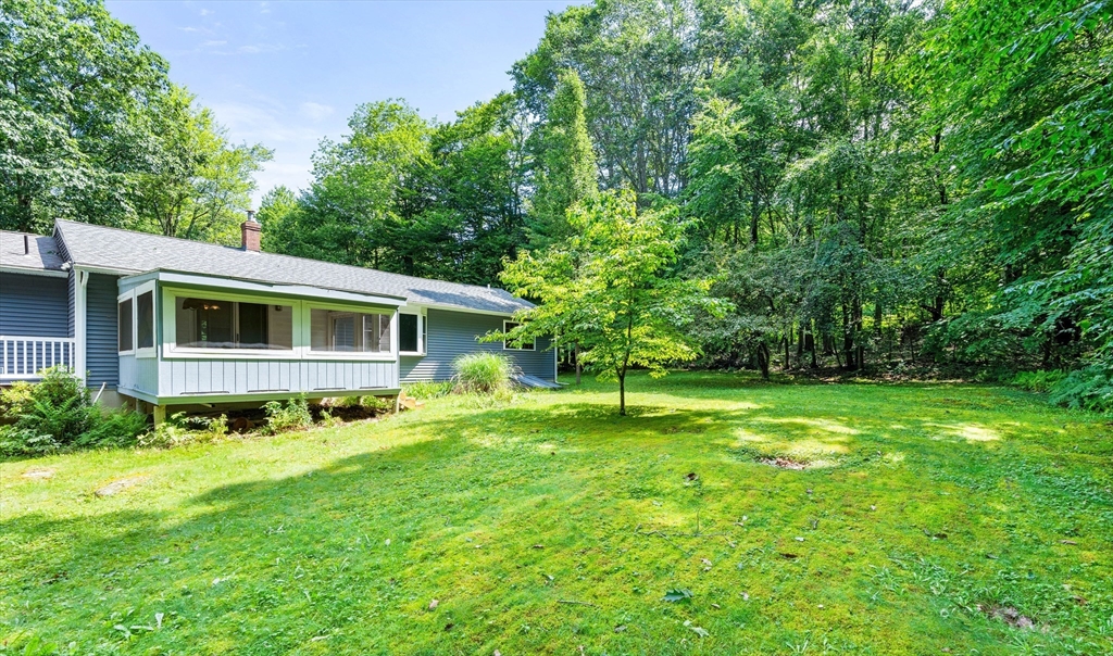 135 Blake Corner Road Phillipston, MA 01331 - Photo 33 of 42 a backyard of a house with plants and large trees