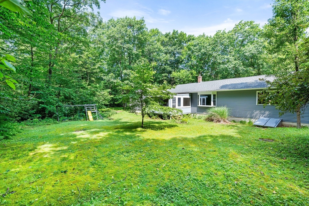 135 Blake Corner Road Phillipston, MA 01331 - Photo 35 of 42 a view of a house with a backyard and a tree