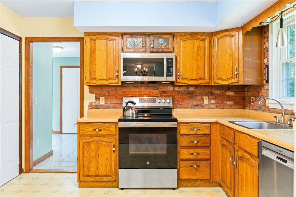 135 Blake Corner Road Phillipston, MA 01331 - Photo 5 of 42 a kitchen with a stove a sink and a microwave
