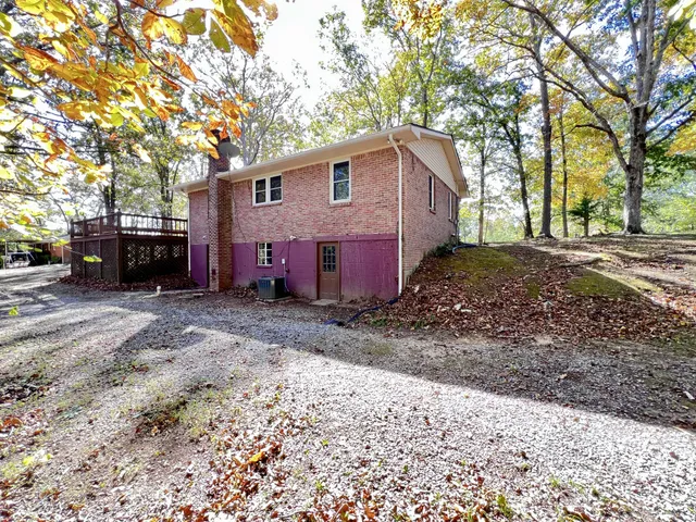a view of a house with a yard covered in snow