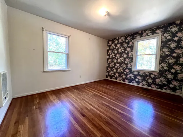 an empty room with wooden floor