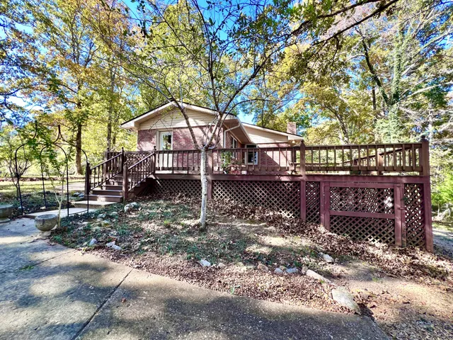 a house that has a tree in front of it