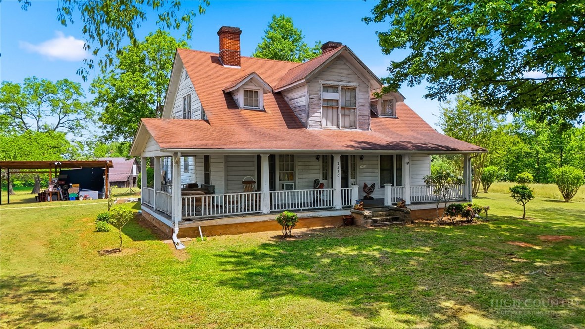 3450 Sparta Road North Wilkesboro, NC 28659 - Photo 1 of 34 a front view of a house with swimming pool having outdoor seating