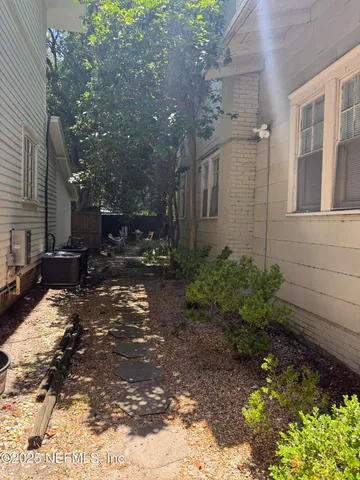 a view of backyard with patio