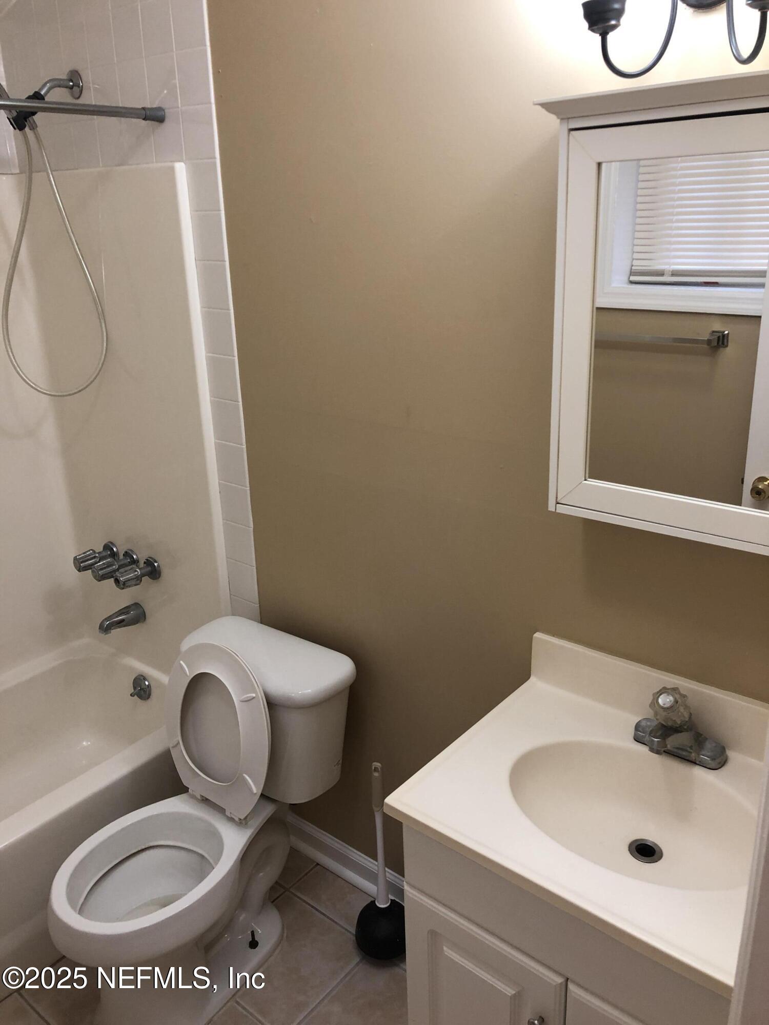 1252 Donald Street, Unit C Jacksonville, FL 32205 - Photo 5 of 7 a bathroom with a sink a toilet and a mirror