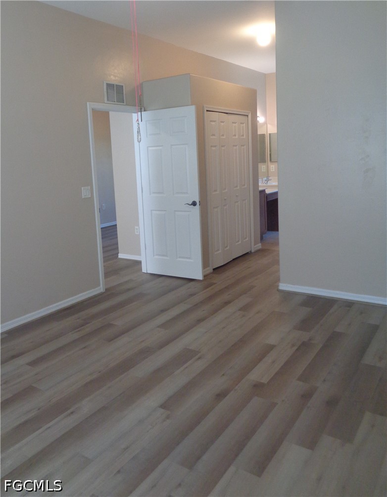 2463 Nature Pointe Loop Fort Myers, FL 33905 - Photo 23 of 50 an empty room with wooden floor and windows