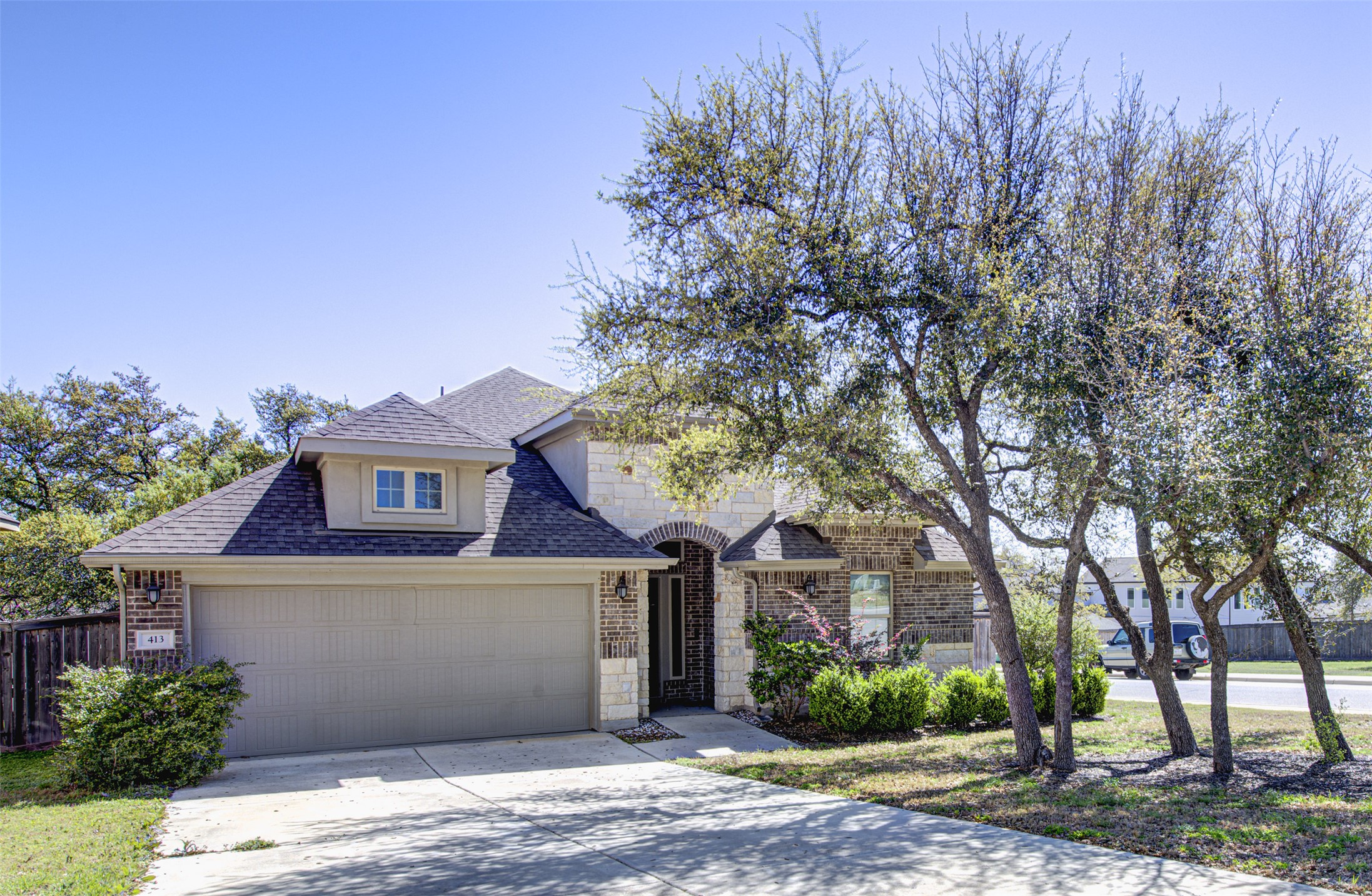 413 Pinnacle View Drive Georgetown, TX 78628 - Photo 1 of 31 Traditional home featuring a shingled roof, concrete driveway, brick siding, and stone siding