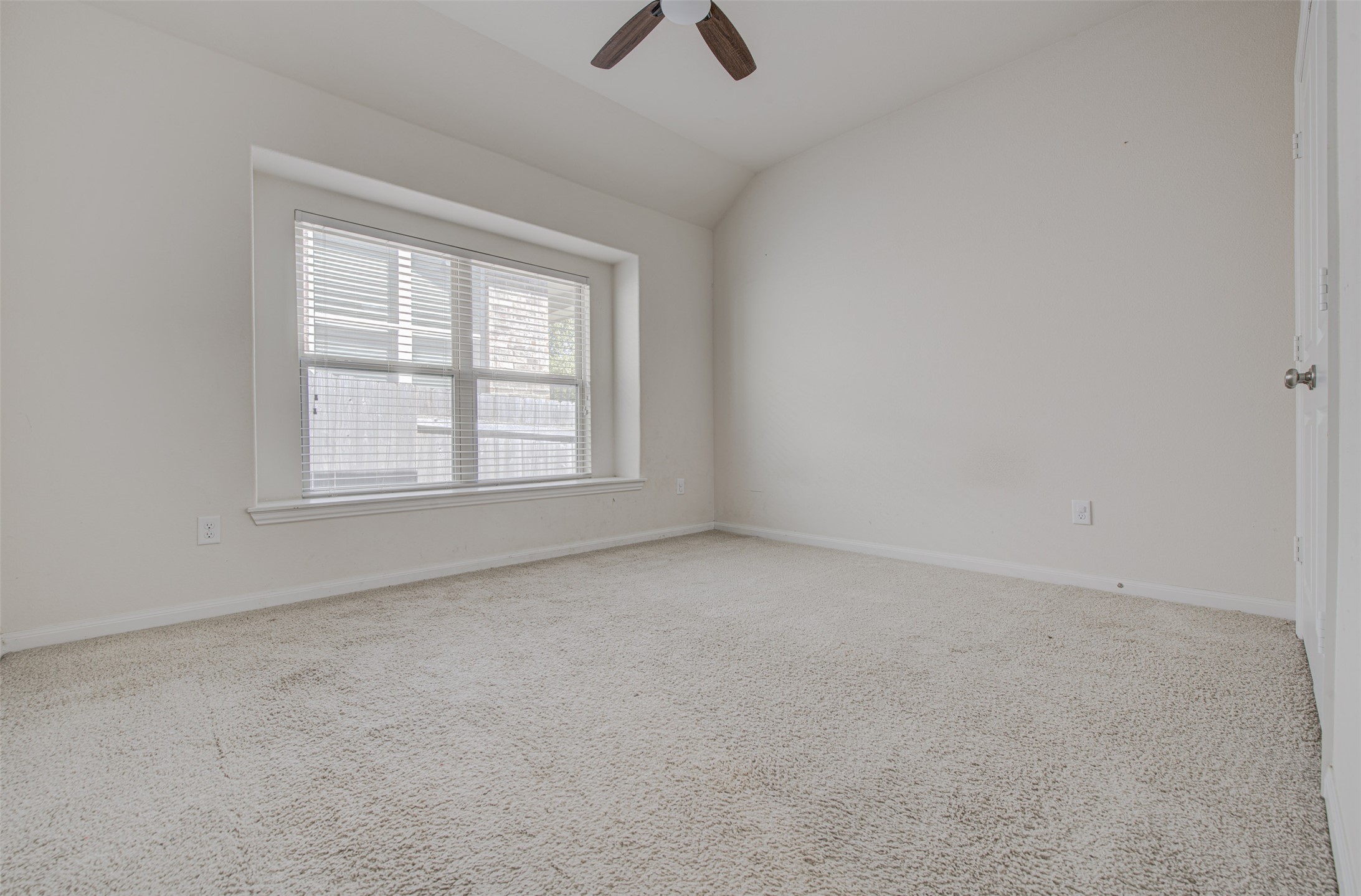413 Pinnacle View Drive Georgetown, TX 78628 - Photo 14 of 31 Unfurnished room featuring carpet, ceiling fan, and vaulted ceiling
