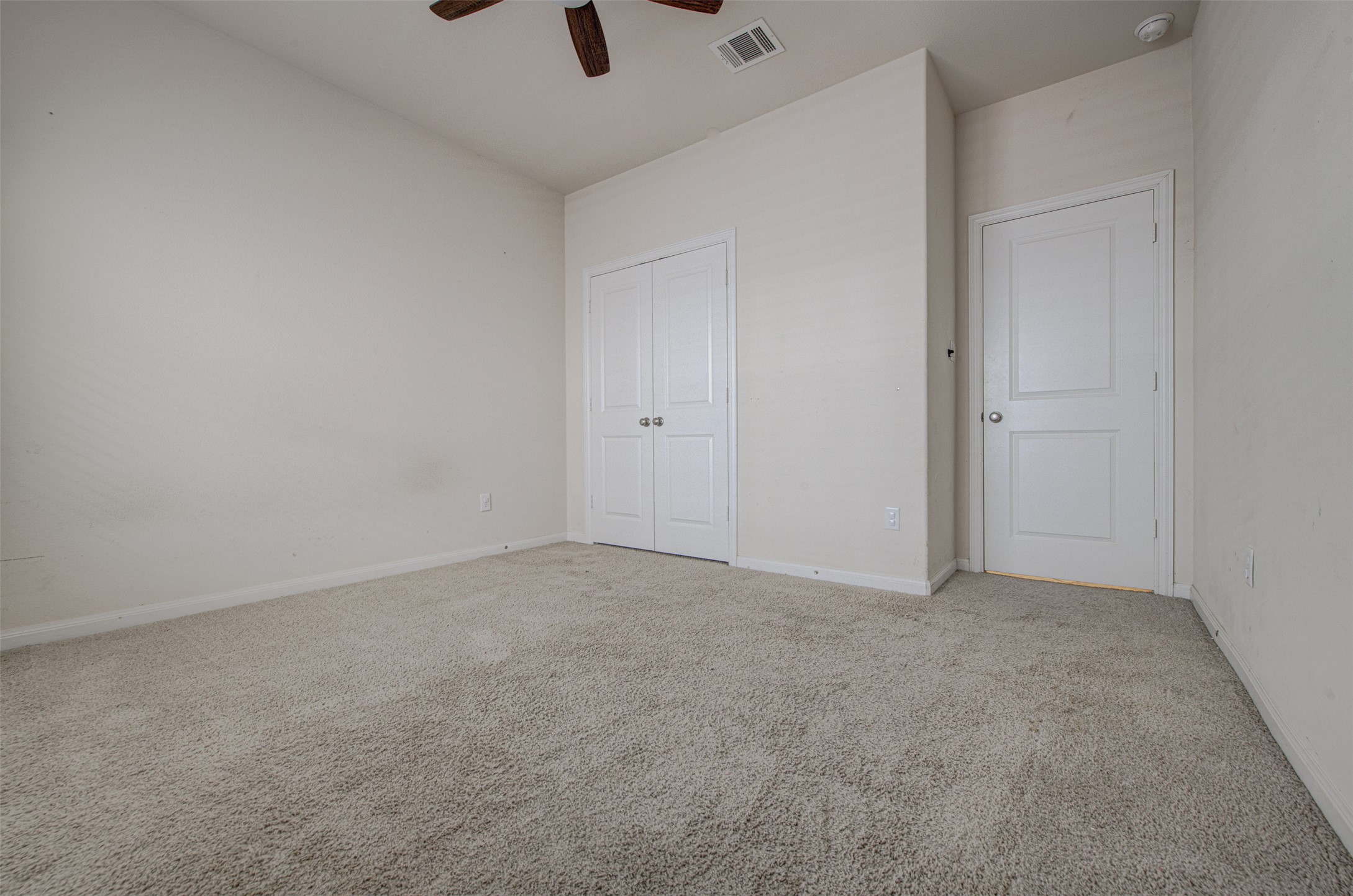 413 Pinnacle View Drive Georgetown, TX 78628 - Photo 15 of 31 Unfurnished bedroom featuring light colored carpet, a closet, and a ceiling fan