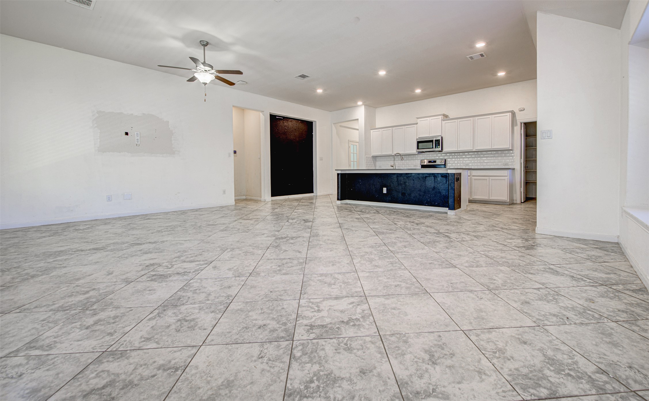 413 Pinnacle View Drive Georgetown, TX 78628 - Photo 31 of 31 Kitchen with open floor plan, an island with sink, ceiling fan, light countertops, and recessed lighting