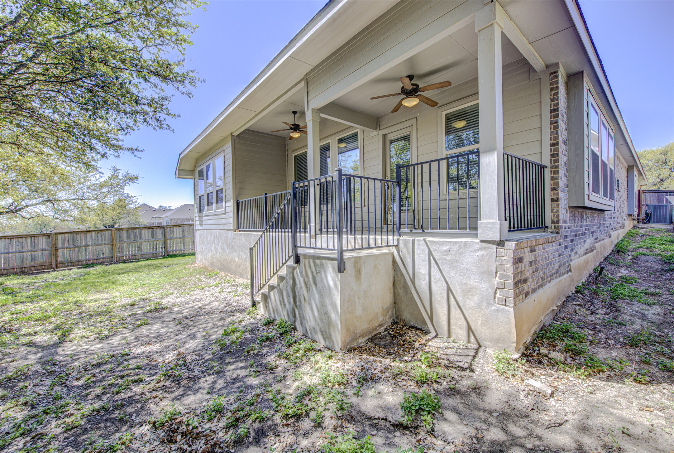 413 Pinnacle View Drive Georgetown, TX 78628 - Photo 30 of 31 View of property exterior featuring a ceiling fan, brick siding, and covered porch