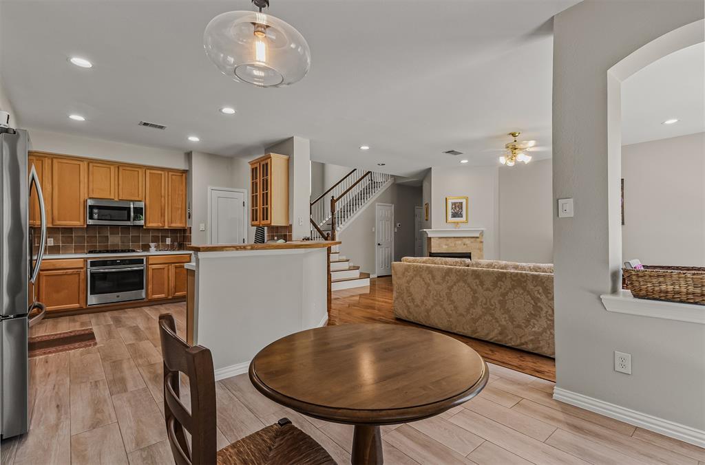 9301 Nottingham Court Rowlett, TX 75088 - Photo 24 of 39 Open-concept kitchen and living area featuring wood-finish flooring, recessed lighting, and a neutral color palette