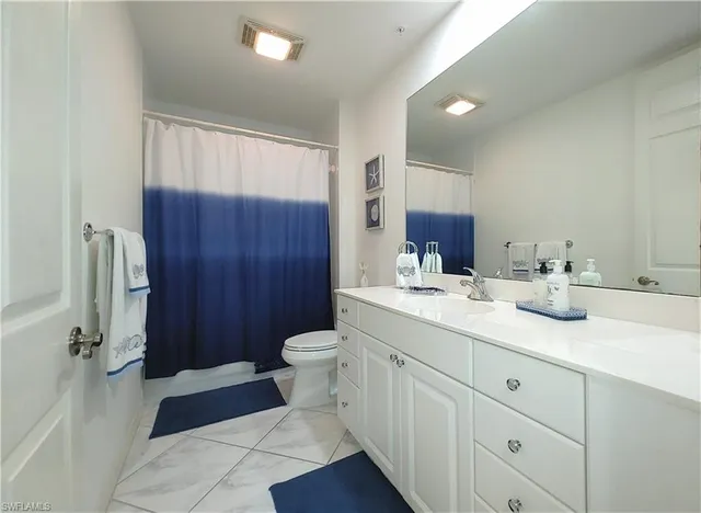 a bathroom with a sink double vanity granite and a mirror