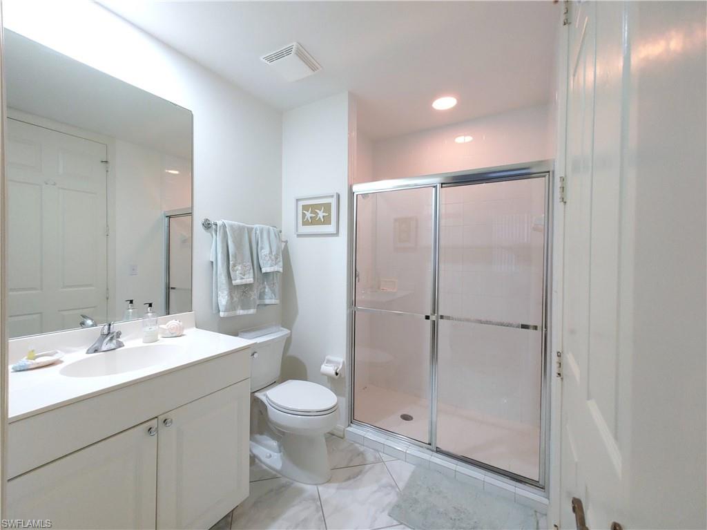 400 Flagship Drive, Unit 704 Naples, FL 34108 - Photo 17 of 28 a bathroom with a toilet sink and shower