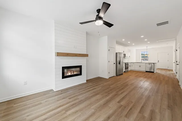 a view of a kitchen and an empty room