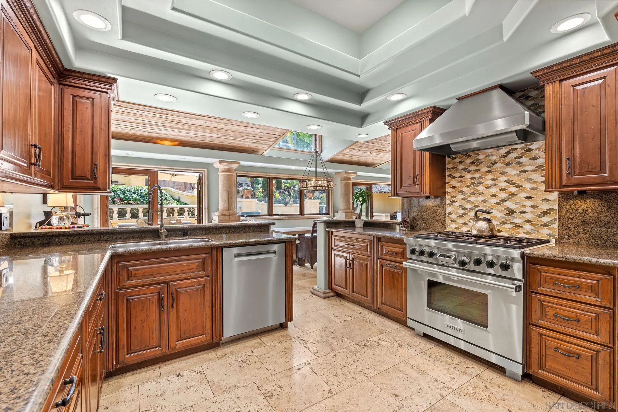 2969 Racetrack View Drive Del Mar, CA 92014 - Photo 22 of 74 a kitchen with stainless steel appliances granite countertop a stove a sink and a microwave