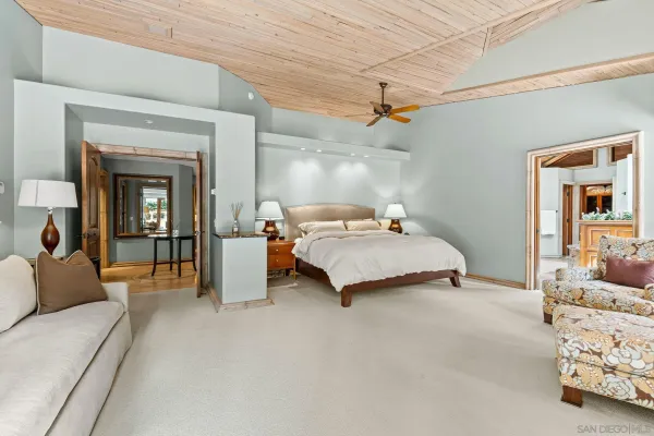 a bedroom with a large bed and a large window