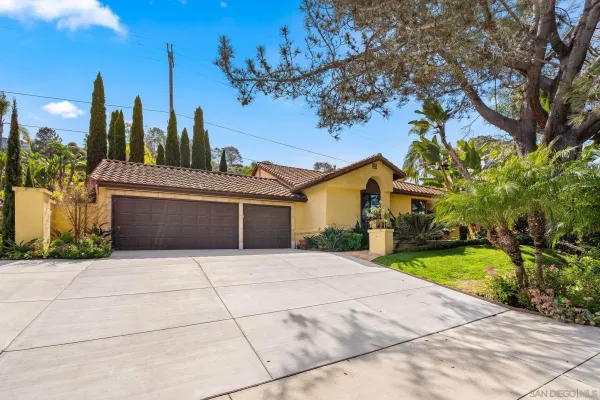 a living room with furniture a clock and a large window
