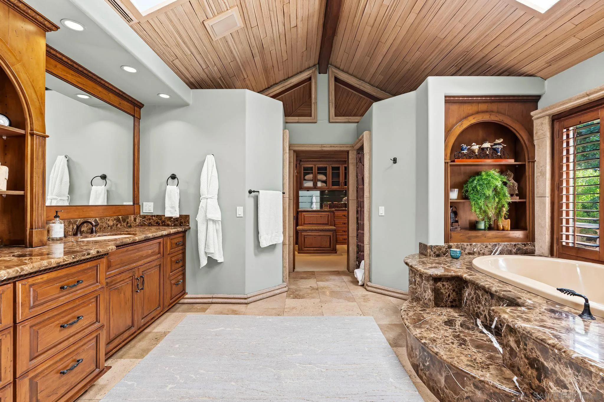 2969 Racetrack View Drive Del Mar, CA 92014 - Photo 32 of 74 a spacious bathroom with a granite countertop sink a large mirror and a bathtub