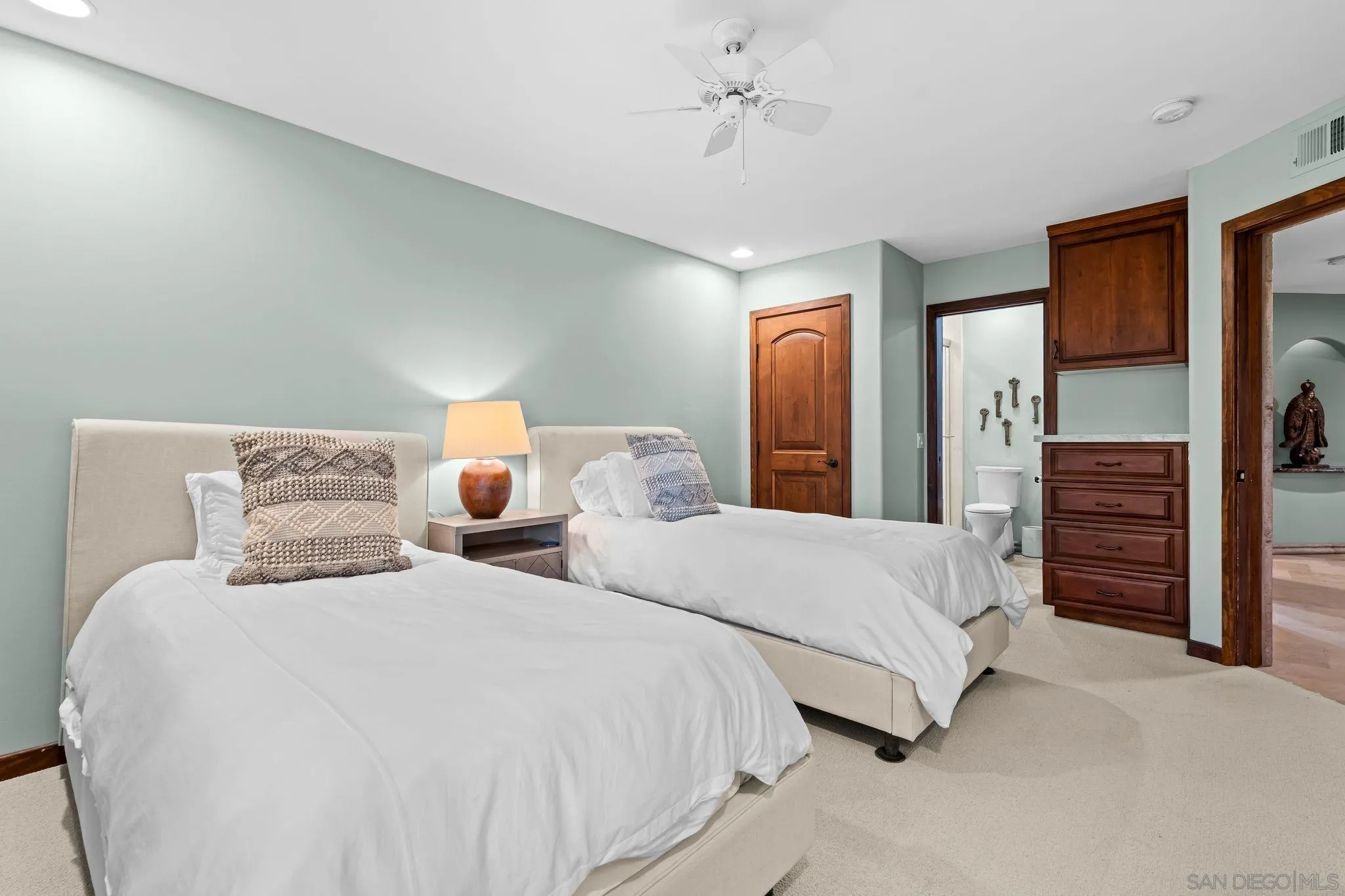2969 Racetrack View Drive Del Mar, CA 92014 - Photo 43 of 74 a spacious bedroom with two bed and a chandelier