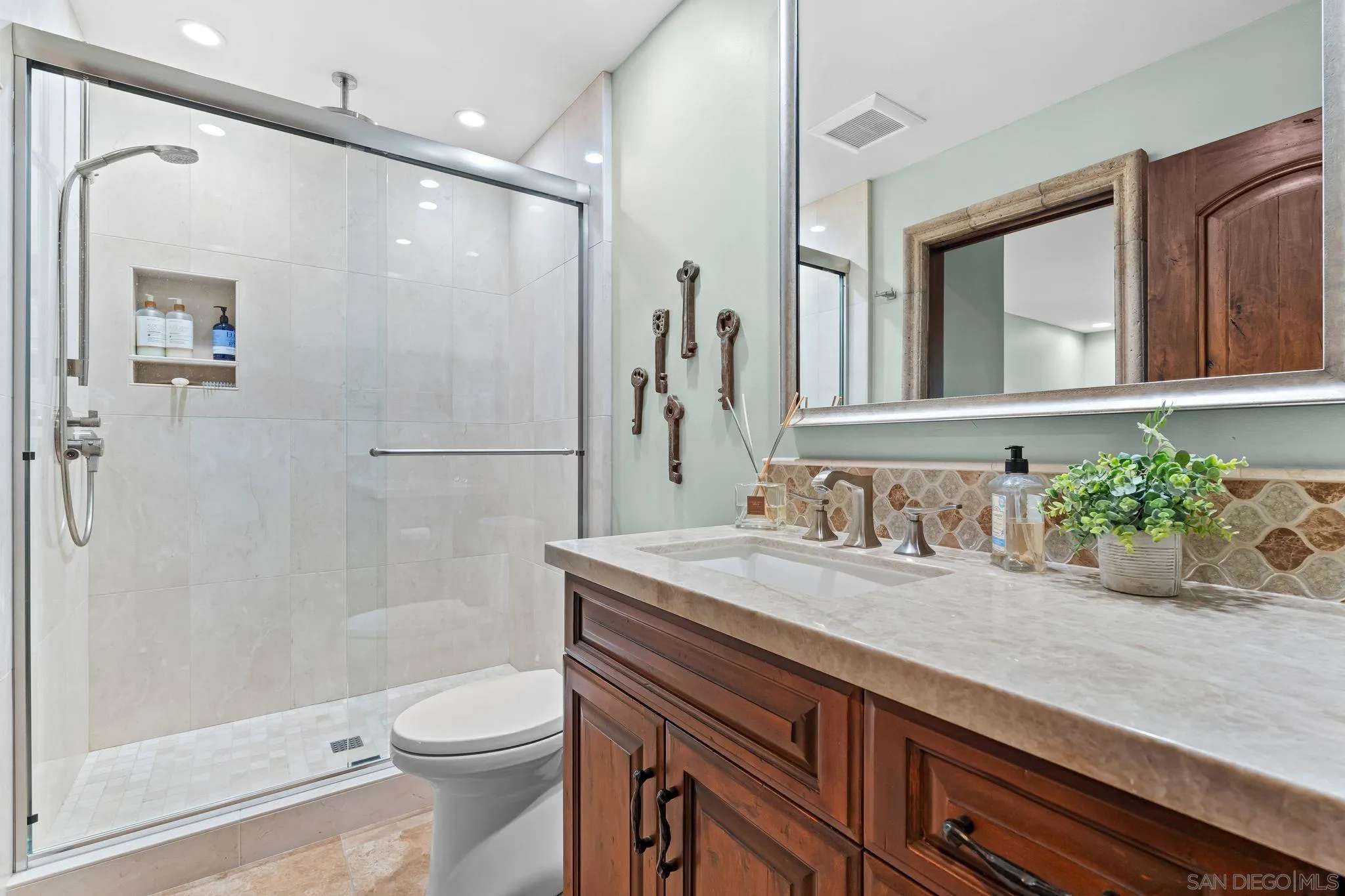2969 Racetrack View Drive Del Mar, CA 92014 - Photo 44 of 74 a bathroom with a granite countertop sink a toilet a mirror and shower