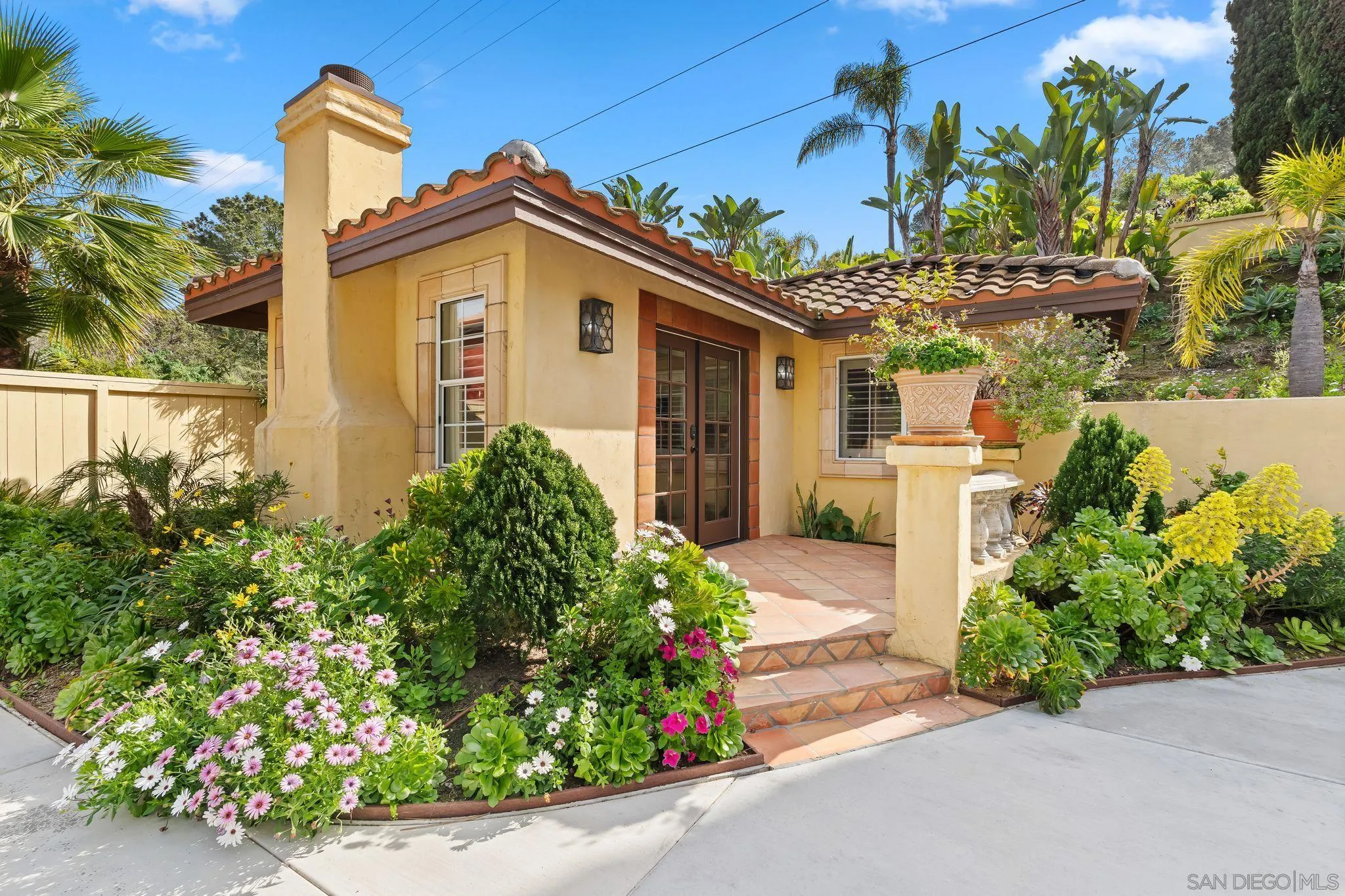 2969 Racetrack View Drive Del Mar, CA 92014 - Photo 62 of 74 a front view of a house with a yard and garage