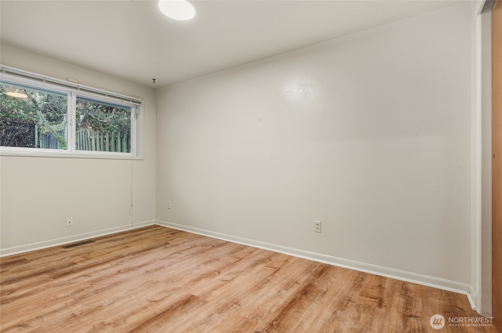 7942 15th Avenue Southwest Seattle, WA 98106 - Photo 16 of 31 wooden floor in an empty room with a window