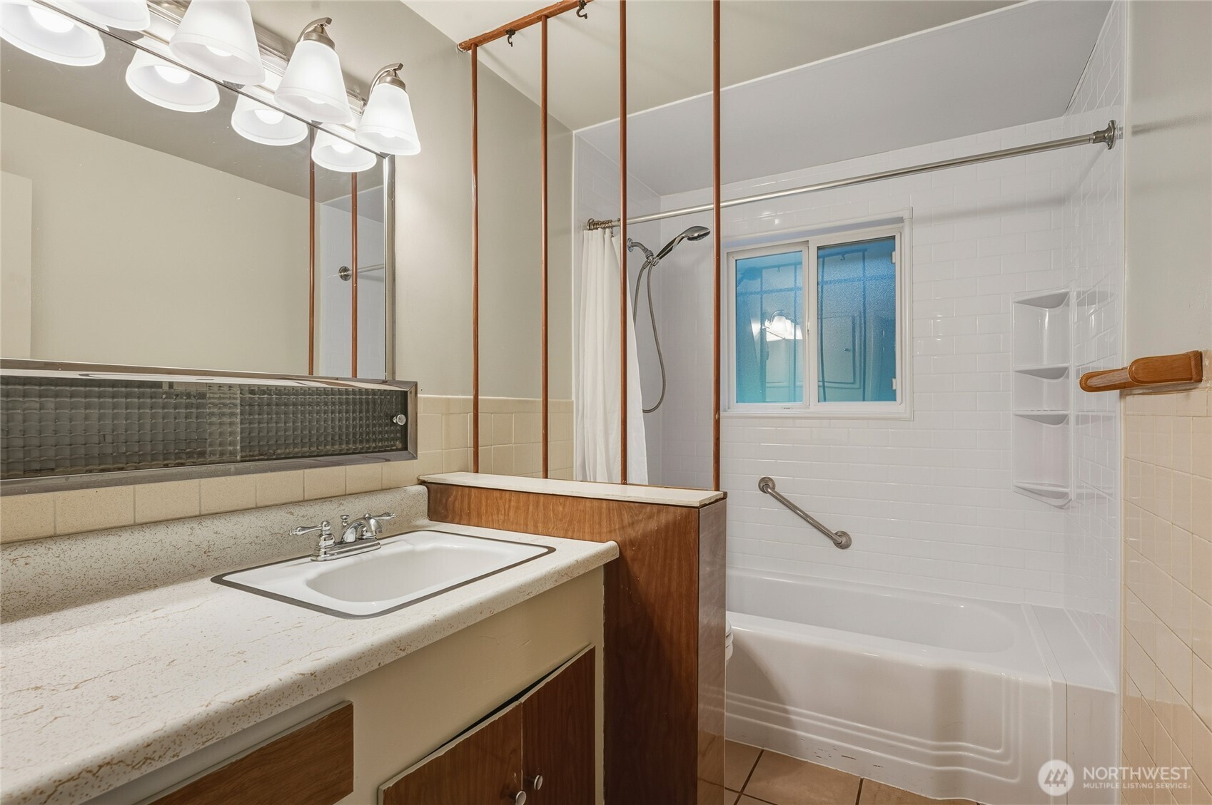 7942 15th Avenue Southwest Seattle, WA 98106 - Photo 18 of 31 a bathroom with a sink a mirror and a bathtub