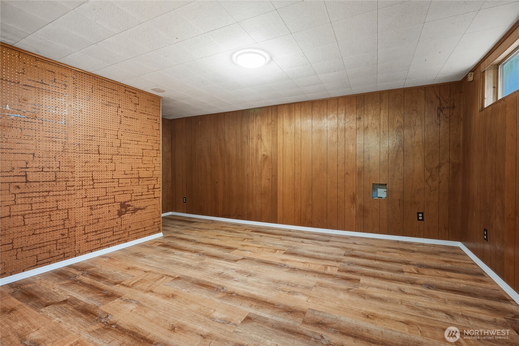 7942 15th Avenue Southwest Seattle, WA 98106 - Photo 22 of 31 a view of an empty room with a wooden floor