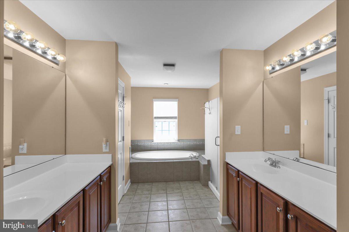 12 Hidden Brook Way Reading, PA 19608 - Photo 20 of 23 a bathroom with a sink a toilet a mirror and a tub