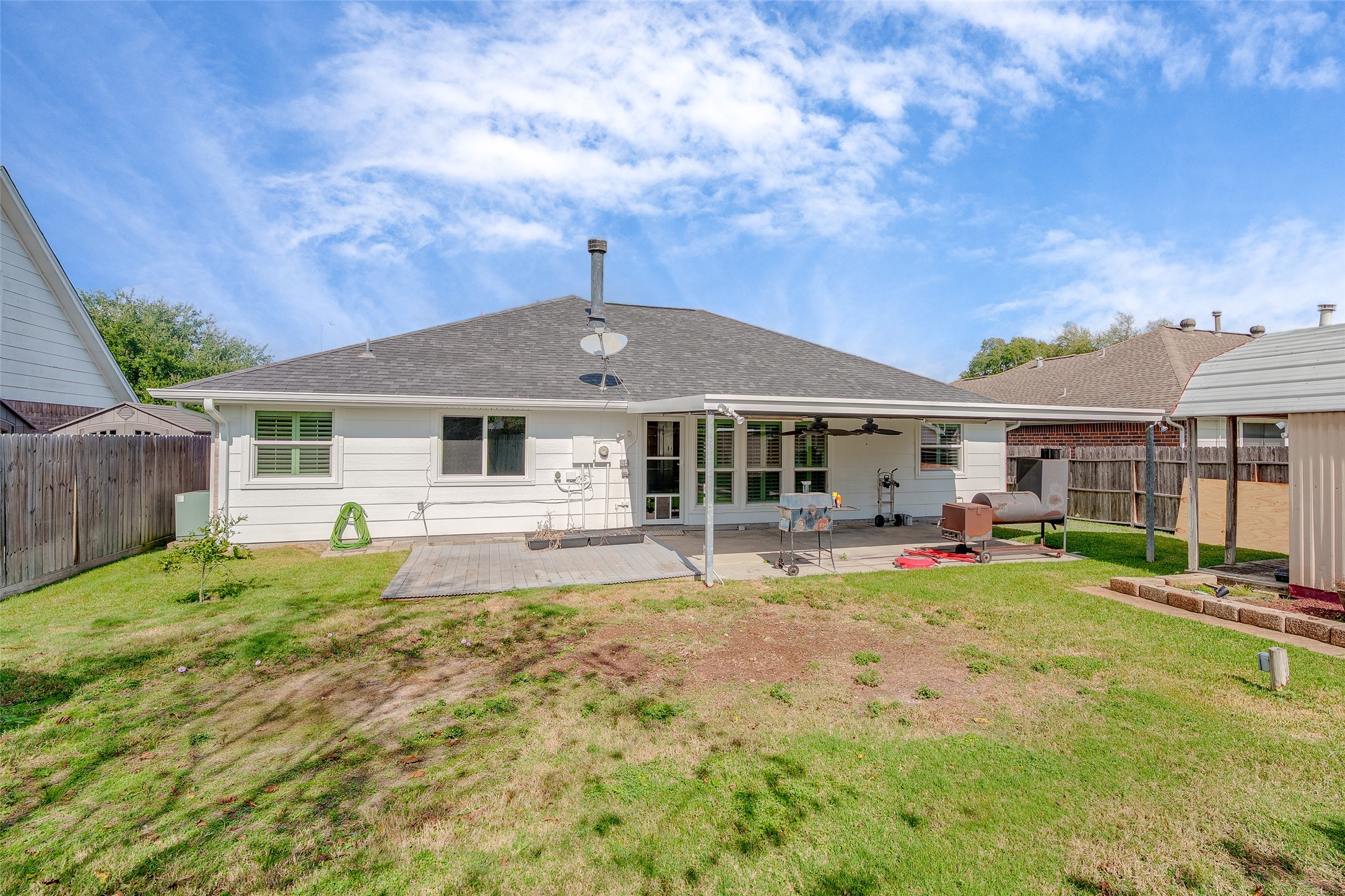 4826 Stonebridge Street Baytown, TX 77521 - Photo 11 of 18 Enjoy this fenced-in backyard with lush lawn and a spacious covered patio, perfect for outdoor gatherings, relaxing in the sun, or creating your own garden oasis.