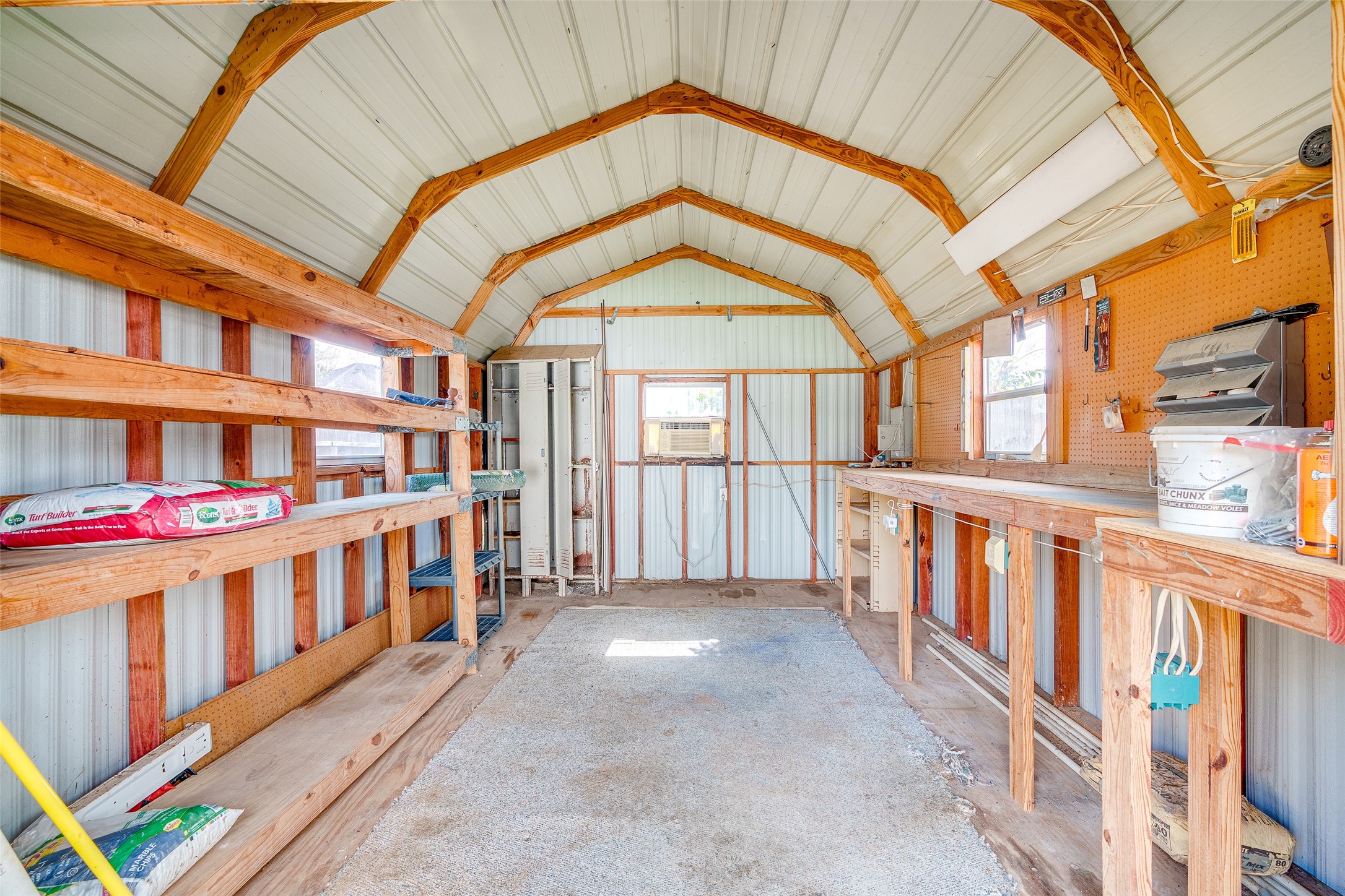 4826 Stonebridge Street Baytown, TX 77521 - Photo 13 of 18 Step inside the spacious shed, where generous square footage and an open layout provide endless possibilities for storage, hobbies, or a personalized workshop—all in a clean, well-maintained space ready for your needs.